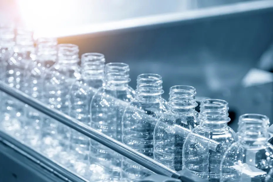 Bottle necks and mouths of empty PET bottles on the conveyor belt of a filling line before filling